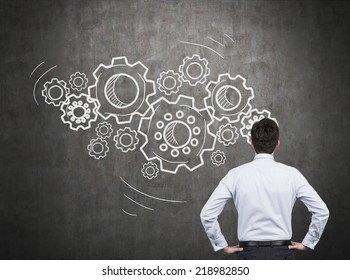 Businessman with gears - A concept of well organized work process.