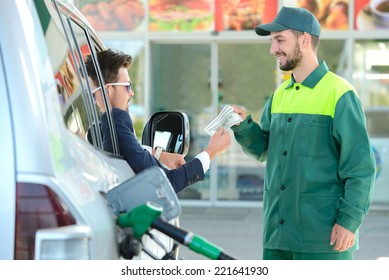 Businessman Give Money Dispensers, Filled Car On Gas Station