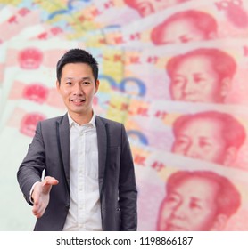 Businessman Gives A Handshake With China Banknote Background. Business Deal Or Agreement And Success Concept.