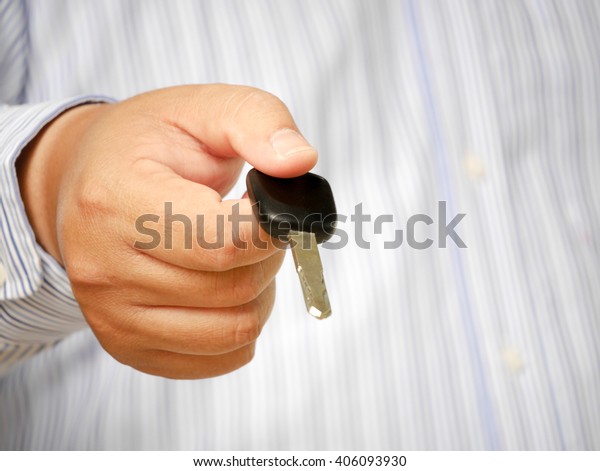 Businessman gives the keys to\
the car.