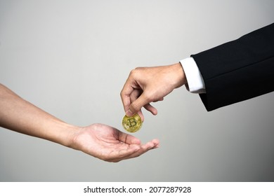 Businessman giving golden bitcoin to another man. two hands exchanging cryptocurrency.