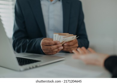 Businessman giving money to his partner while making contract - bribery and corruption concepts - Shutterstock ID 2171204645