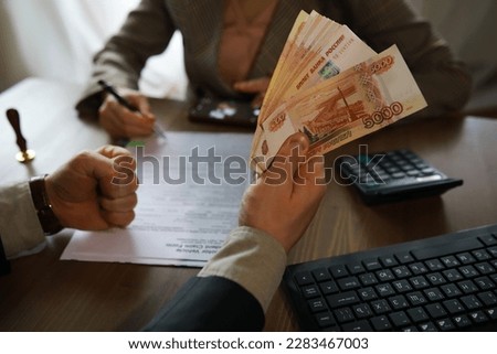 Businessman giving money, Russian Ruble currency, to hs partner - payment, loan bribery concept