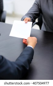 Businessman Giving Paper To Hos Colleague In Office