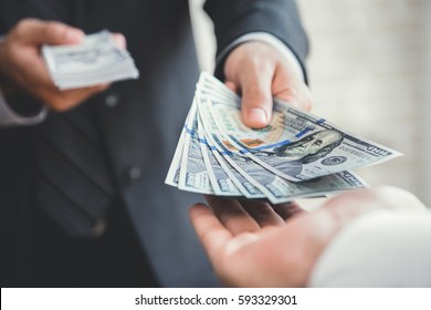 Businessman Giving Or Paying Money To A Man, US Dollar (USD) Bills - Lending, Loan And Financial Concepts
