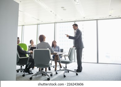 Businessman Giving Presentation In Conference Room