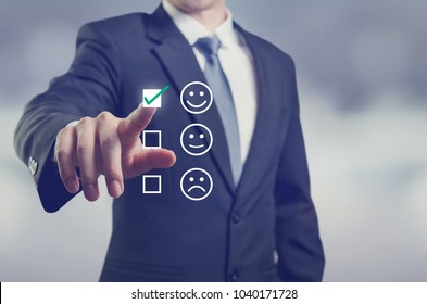 Businessman giving rating with happy icon, Customer satisfaction survey concept