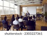 Businessman giving report or presentation to business colleagues. Professional coach consulting, training, explaining strategy to interested people, giving educational workshop in conference room