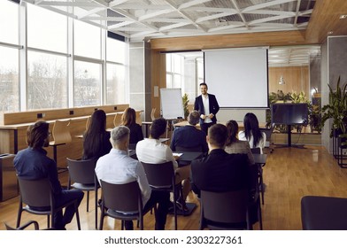 Businessman giving report or presentation to business colleagues. Professional coach consulting, training, explaining strategy to interested people, giving educational workshop in conference room - Shutterstock ID 2303227361