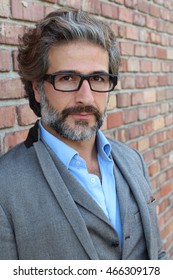 Businessman With Glasses In Classic Suit With Salt And Pepper Hair And Beard