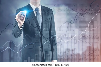 Businessman With A Glowing Marker Drawing A Brain Hologram. A Foggy Cityscape Background With Graphs. Toned Image Double Exposure Mock Up