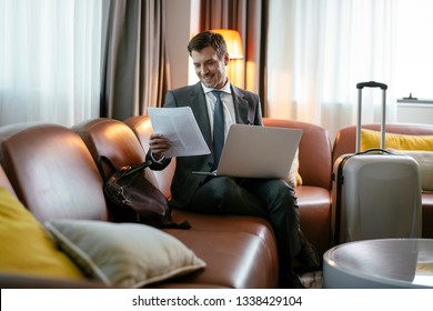 Businessman Going Through His Papers. Boss At A Hotel Room. Manager Preparing His Files.