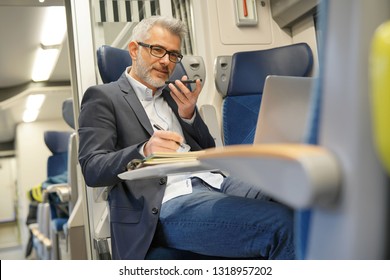 Businessman Going To Work By Train, Talking On Phone