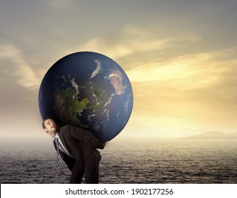 Businessman golding earth on his back, environmental concept, elements of this image furnished by NASA