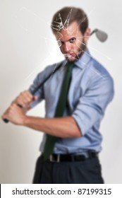 Businessman With Golf Club Through A Broken Glass