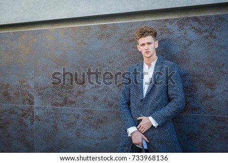 Businessman in gray coat. The concept of career and entrepreneurship.