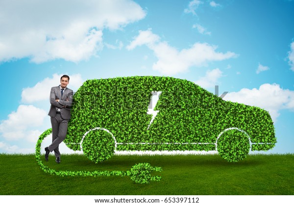 Businessman in green\
electric car\
concept