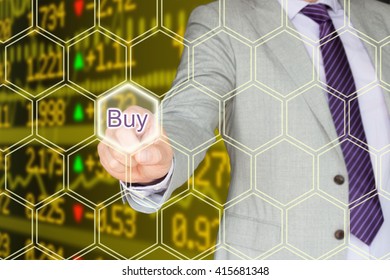 Businessman In A Grey Suit Pressing The Buy Button An A Hexagon Grid N Front Of A Stock Ticker Wall