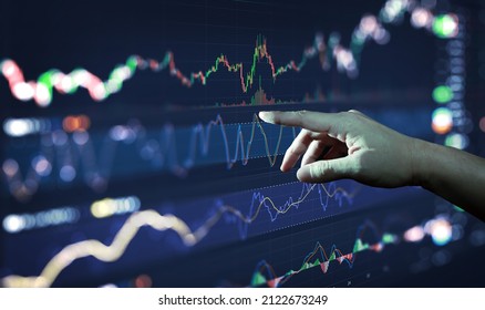Businessman hand analysing financial stock market graph on board. Trading data index investment growth chart. Cryptocurrency and Forex Concept. - Shutterstock ID 2122673249