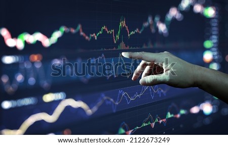 Businessman hand analysing financial stock market graph on board. Trading data index investment growth chart. Cryptocurrency and Forex Concept.