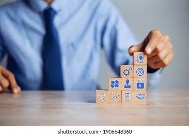 Businessman Hand Arranging Wood Block With Icon Business Strategy And Action Plan