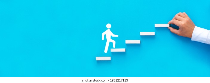 Businessman hand arranging wood block stacking as step stair with figure climb up the ladder of success.  Business start-up, development and success. - Shutterstock ID 1951217113