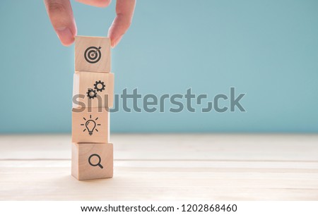 Businessman hand arranging wood block with icon business strategy and Action plan, copy space.