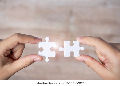 Businessman hand connecting couple puzzle piece. Business solutions, mission target, successful, goals, cooperation, partnership and strategy concept - Shutterstock ID 1514539202