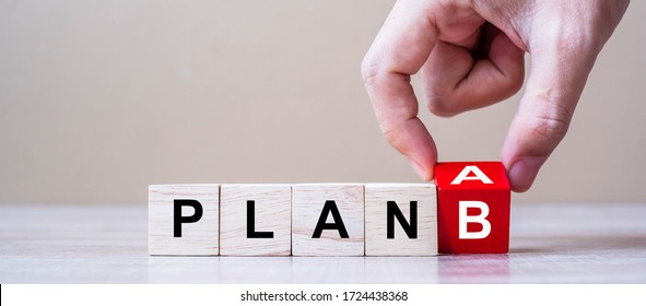 Businessman hand flipping wooden cube blocks with PLAN A change to PLAN B text on table background. strategy, analysis, marketing, project and Crisis concepts