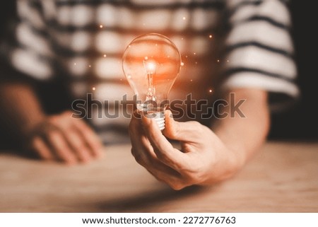 Businessman hand hold lightbulb,Science communication. Global Internet connection, New ideas inspiration innovation, Digital link technology, Big data, Financial banking