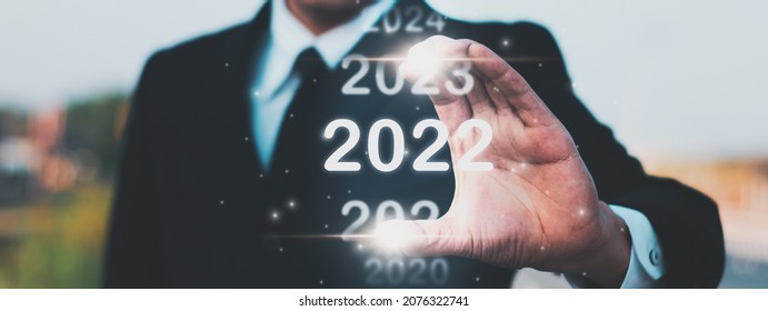 Businessman Hand Holding 2022 Year Number,start Happy New Year Concept Digital Trends,industry And Business Trend Of World Full Modernity Advanced Technology,calendar Happy New Year