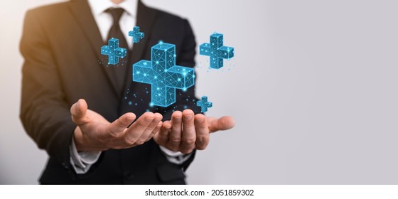 Businessman hand holding 3D plus low polygonal icon.Plus sign virtual means to offer positive thing like benefits, personal development, social network Profit,health insurance, growth concepts - Shutterstock ID 2051859302