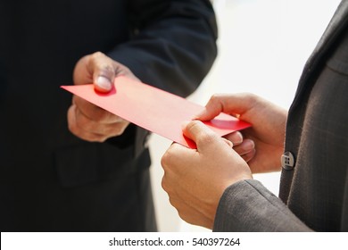 Businessman Hand holding award year bonus Chinese red envelope