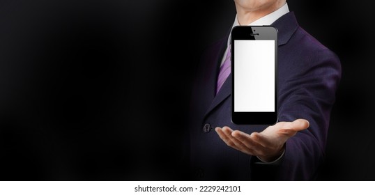 Businessman hand holding the black smartphone with blank screen isolated black background.online gadget shopping on black friday.smartphone with screen mockup.man with suite show phone display tech. - Shutterstock ID 2229242101