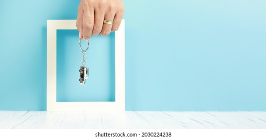 Businessman Hand Holding A Car Key Chain, Insurance Concept