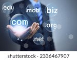 Businessman hand holding and choosen bubble sub domain name to dot com or .com to registeration the commercial website. Domain selection concept.