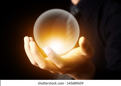 Businessman hand holding a Crystal Ball