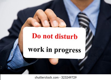 Businessman Hand Holding Do Not Disturb, Work In Progress Concept