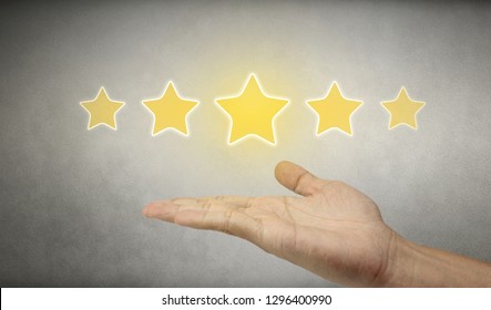 Businessman Hand Holding Five Star Symbol To Increase Rating Of Company Concept.