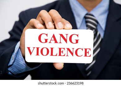 Businessman Hand Holding GANG VIOLENCE Concept