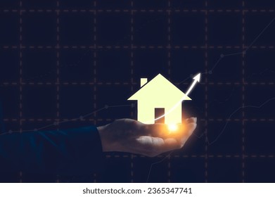 businessman hand holding house icon in concept of real estate investment, energy efficiency rating and property value, Real estate online on virtual screens, home search, land price, property tax - Shutterstock ID 2365347741