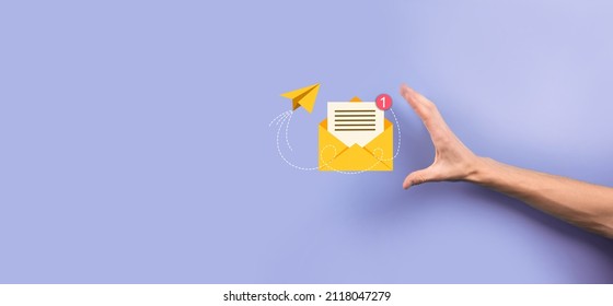 Businessman hand holding letter icon,email icons.Contact us by newsletter email and protect your personal information from spam mail.Customer service call center contact us.Email marketing newsletter - Shutterstock ID 2118047279