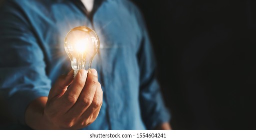 businessman hand holding lightbulb. idea Alternative energy concept saving electricity - Shutterstock ID 1554604241
