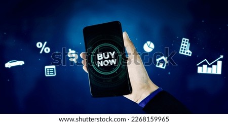 Businessman hand holding a mobile phone with buy now button on futuristic background