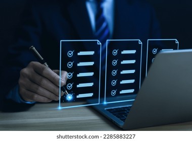 Businessman hand holding a pen ticking checkmark on a box in the list Show on the virtual screen. Checklist Ideas in Business Survey items and questionnaires. copy space - Shutterstock ID 2285883227