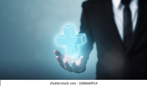 Businessman hand holding plus sign virtual means to offer positive thing (like benefits, personal development, social network) - Shutterstock ID 1068660914