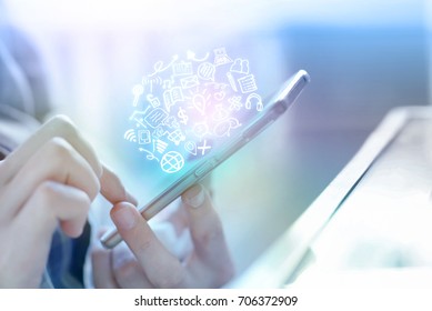 businessman hand holding smart phone connecting to internet and social media icons, people with technology concept background - Powered by Shutterstock