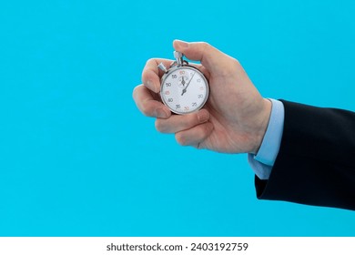 Businessman hand holding stopwatch on blue background - Powered by Shutterstock