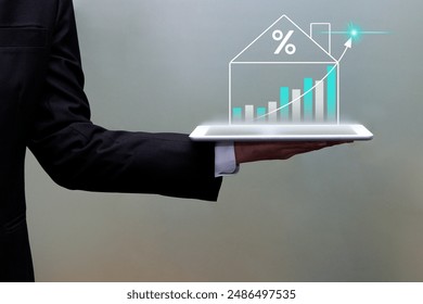 Businessman hand holding tablet showing data analytics graph on virtual screen. Real estate investment, market and analytics concept.