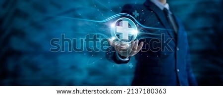 Businessman hand holding virtual medical health care icons with medical network connection. People health care awareness rising growth of medical health and life insurance business.